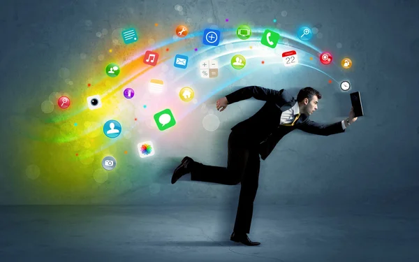 Running businessman with application icons from device — Stock Photo, Image