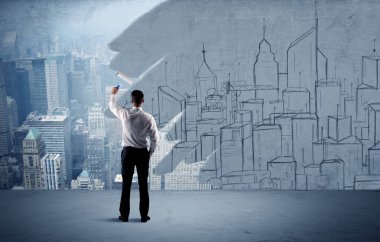 Zarif satıcı şehri duvarda yeniden boyuyor.