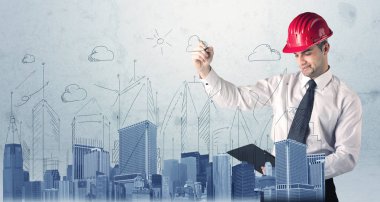 Genç işçi şehir manzarası çiziyor.