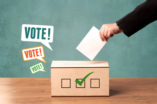 Placing a voting slip into a ballot box — Stock Photo, Image