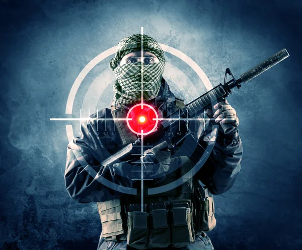 Masked terrorist man with gun and laser target on his body