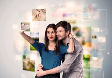 Happy young couple taking selfie pictures clipart