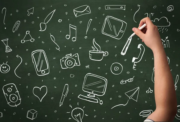 Hand writing icons on blackboard — Stock Photo, Image