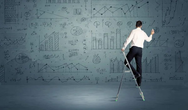 Man on ladder drawing charts