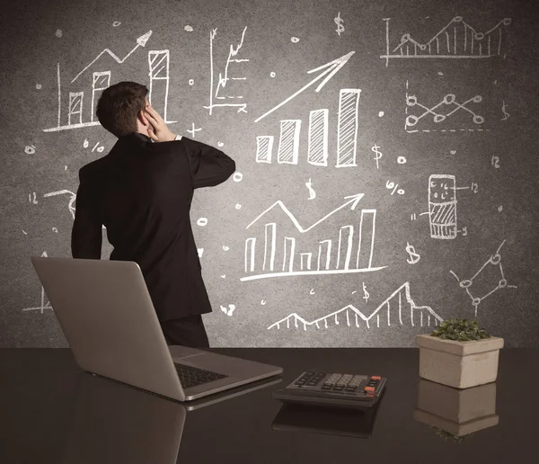 Businessman drawing sales charts on wall — Stock Photo, Image