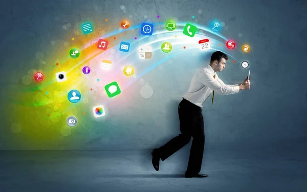 Running businessman with application icons from device — Stock Photo, Image