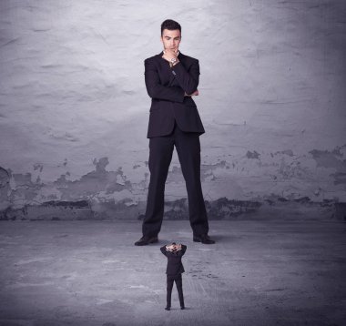 Kızgın büyük müdür küçük iş adamına bakıyor.