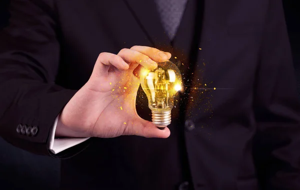 Office worker holding a light bulb — Stock Photo, Image