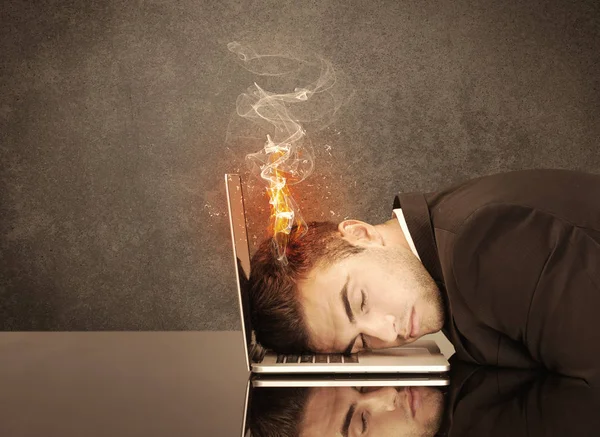 Sad business person's head catching fire