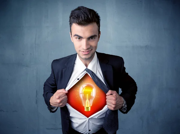 Businessman ripping off shirt and idea light bulb appears