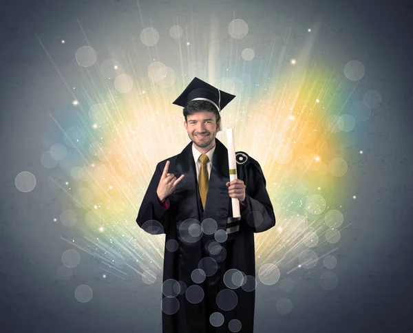 Feliz graduado con luces bokeg de colores en el fondo —  Fotos de Stock