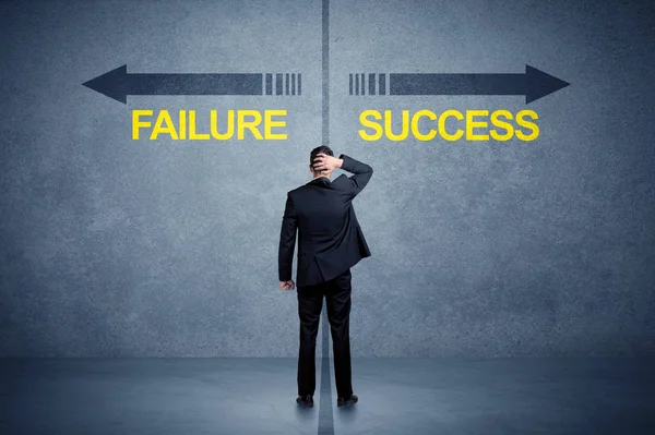 Businessman standing in front of success and failure arrow conce — Stock Photo, Image