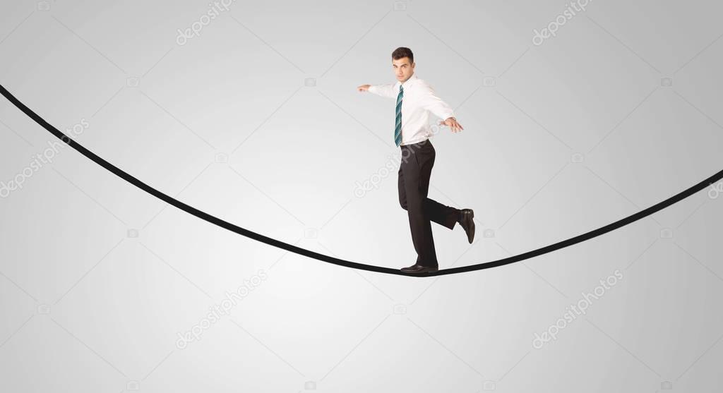 Happy businessman walking on rope