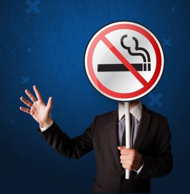 Hiç Sigara İçilmez işareti tutan işadamı