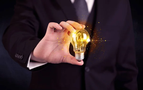 Office worker holding a light bulb — Stock Photo, Image