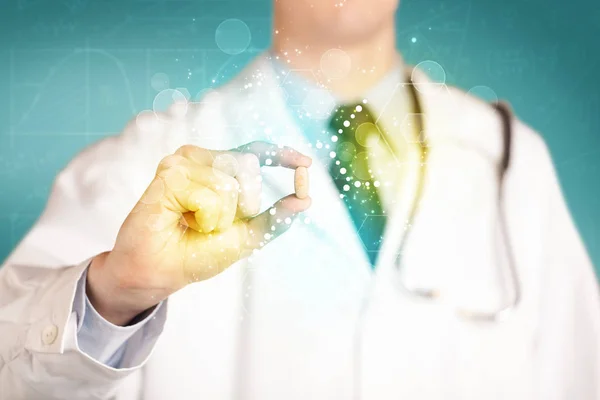 A doctor in tie holding a pill — Stock Photo, Image