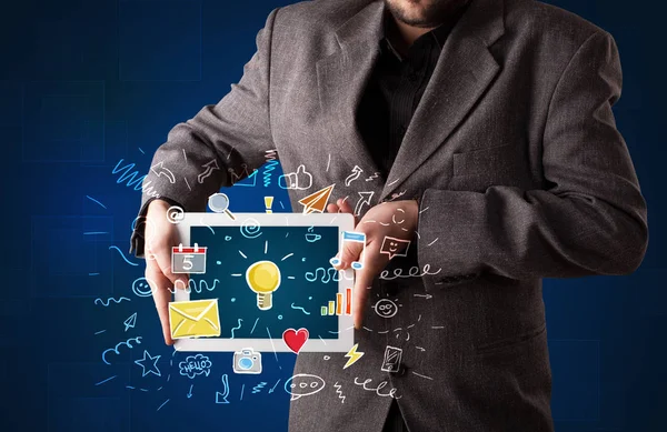 Businessman holding tablet with apps — Stock Photo, Image