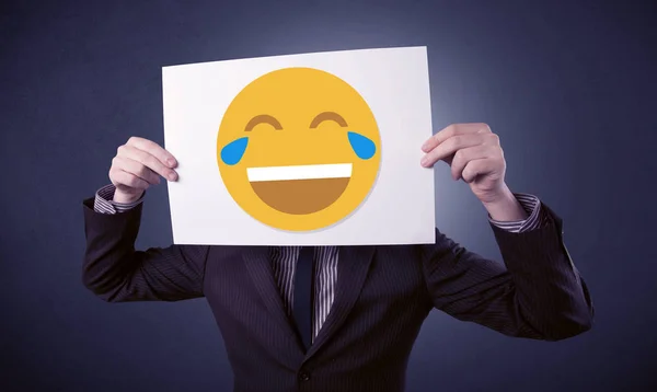 Businessman holding paper with laughing emoticon — Stock Photo, Image