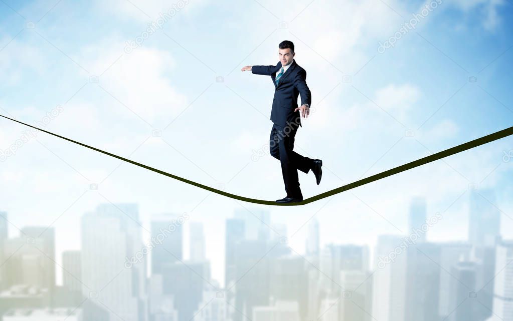 Salesman walking on rope above the city