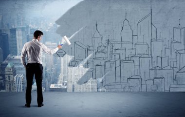 Zarif satıcı şehri duvarda yeniden boyuyor.