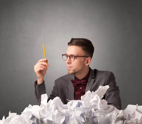 Businessman behind crumpled paper