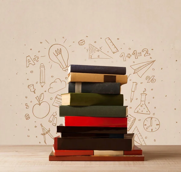 A pile of books on table with school hand drawn doodle sketches — Stock Photo, Image