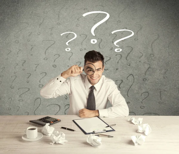 İş adamı soru işaretiyle masada.