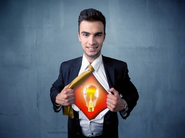 Businessman ripping off shirt and idea light bulb appears
