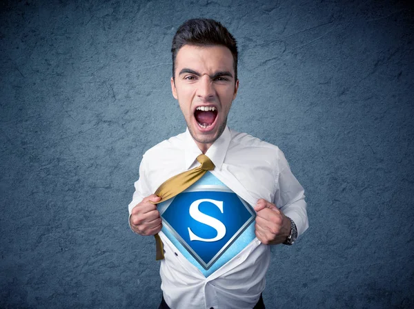 Businessman ripping off his shirt with superhero sign — Stock Photo, Image