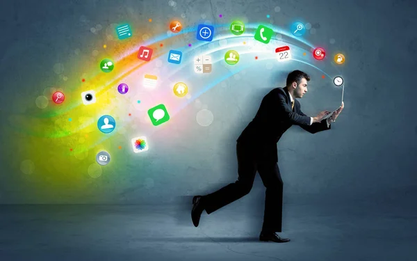 Running businessman with application icons from device — Stock Photo, Image