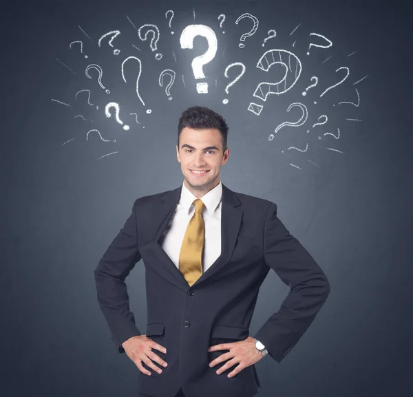 Businessman with question marks — Stock Photo, Image