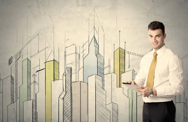 Businessman standing with drawn cityscape — Stock Photo, Image