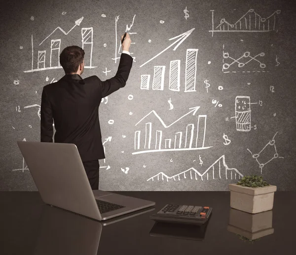 Businessman drawing sales charts on wall — Stock Photo, Image