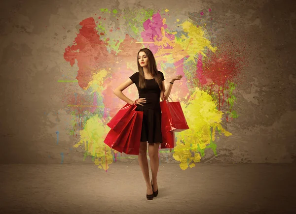 Girl with shopping bags and paint splatter — Stock Photo, Image