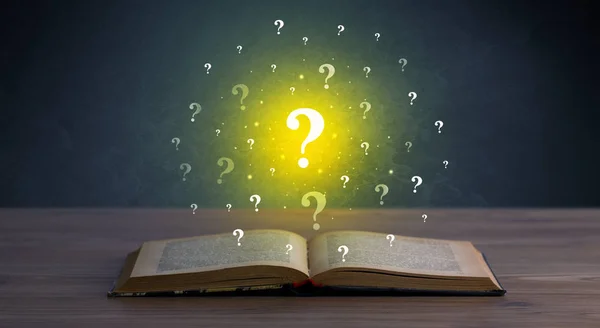 Question marks over book — Stock Photo, Image