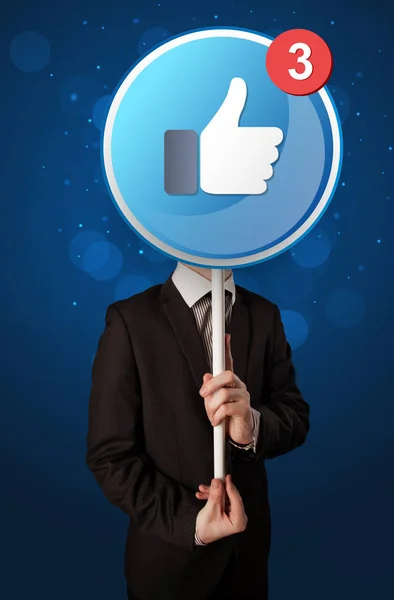 Businessman holding facebook sign — Stock Photo, Image