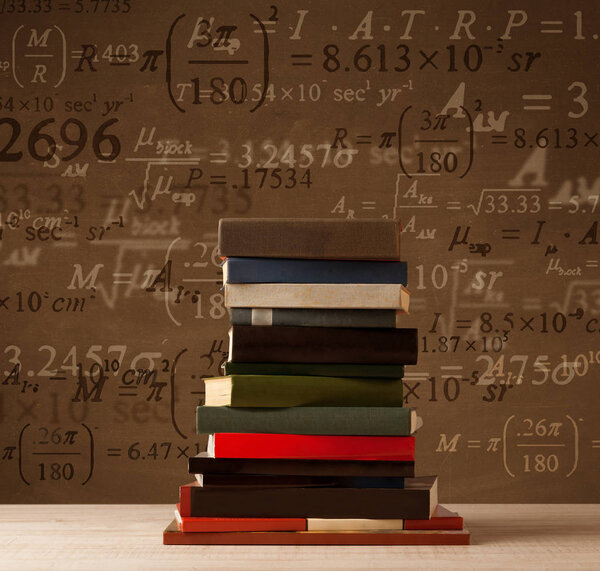 Books on vintage background with math formulas 