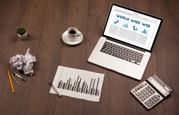 Laptop on wooden desk with office suplies — Stock Photo, Image