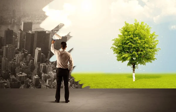 Salesman painting tree instead of city — Stock Photo, Image