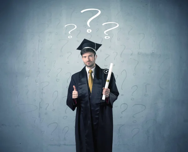 Young graduate teenager with question marks drawn — Stock Photo, Image