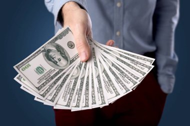 Businessman holding money  clipart