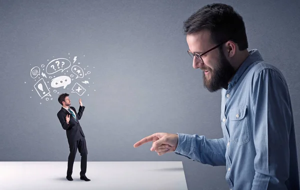 Young businessman fighting with miniature businessman — Stock Photo, Image