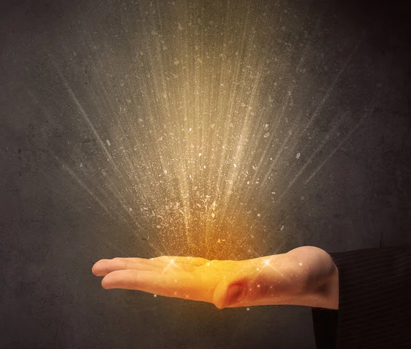 Hand holding yellow light — Stock Photo, Image