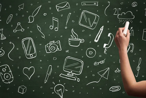 Hand writing icons on blackboard — Stock Photo, Image