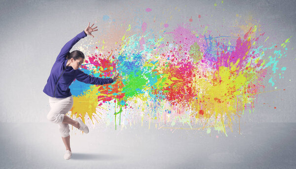 Young colorful street dancer with paint splash