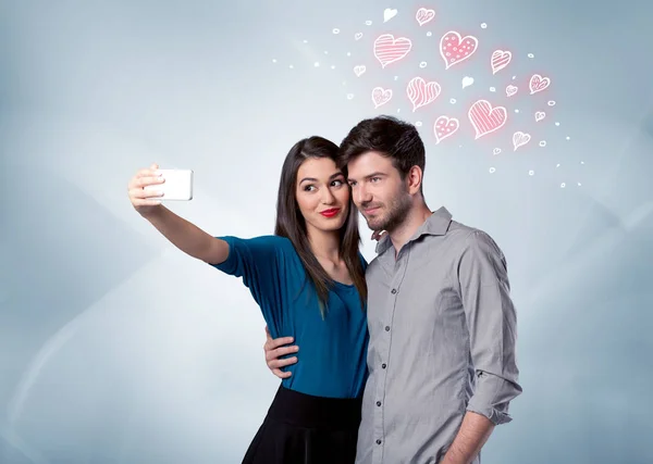 Couple in love taking selfie with red heart — Stock Photo, Image