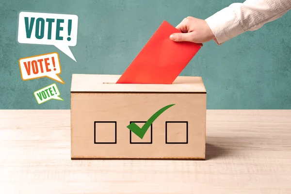 Placing a voting slip into a ballot box — Stock Photo, Image