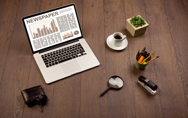 Business laptop with stock market report on wooden desk — Stock Photo, Image