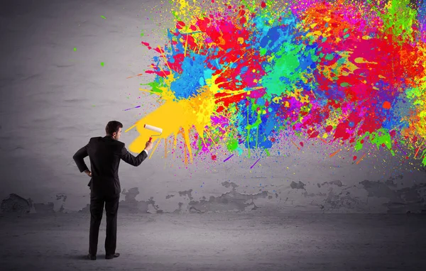 Sales person painting colorful splatter — Stock Photo, Image