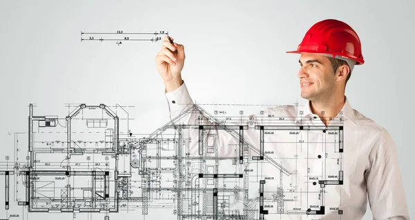 Un joven arquitecto dibujando un plano de la casa — Foto de Stock